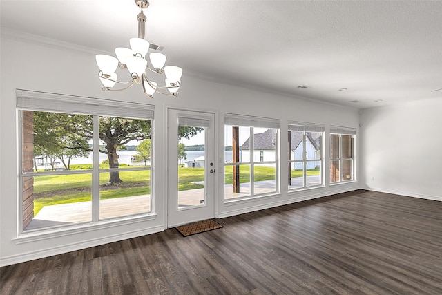 2858 Waters Edge, Quinlan, TX 75474 - interior space with plenty of natural light, dark wood-style floors, and an inviting chandelier