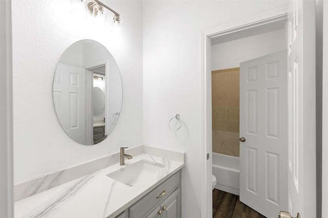 2858 Waters Edge, Quinlan, TX 75474 - full bath featuring wood finished floors, toilet, and vanity