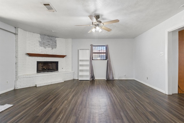 4331 Kolloch Dr, Dallas, TX 75216 - unfurnished living room featuring a ceiling fan, a brick fireplace, wood finished floors, and visible vents