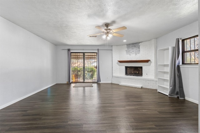 4331 Kolloch Dr, Dallas, TX 75216 - unfurnished living room with a ceiling fan, a brick fireplace, baseboards, and wood finished floors