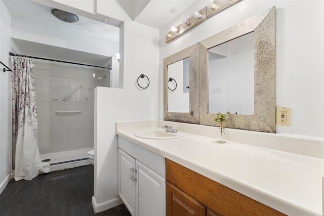 4331 Kolloch Dr, Dallas, TX 75216 - full bathroom featuring toilet, a tile shower, vanity, and wood finished floors
