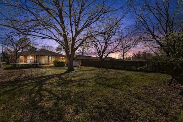 4331 Kolloch Dr, Dallas, TX 75216 - yard at dusk with a trampoline and fence