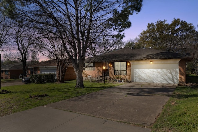 4331 Kolloch Dr, Dallas, TX 75216 - view of front of house with driveway, a front yard, an attached garage, and brick siding