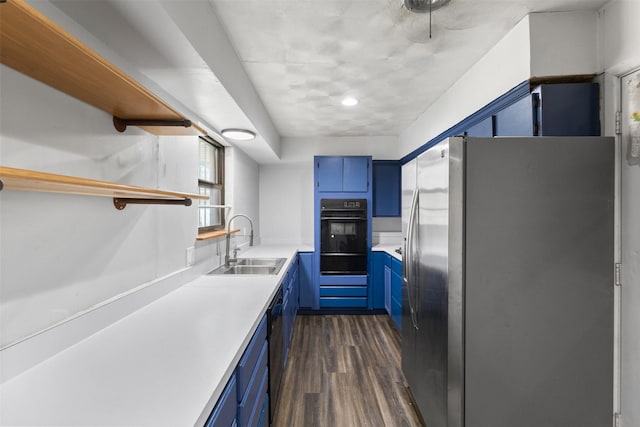 4331 Kolloch Dr, Dallas, TX 75216 - kitchen with blue cabinetry, open shelves, a sink, black oven, and freestanding refrigerator
