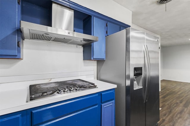 4331 Kolloch Dr, Dallas, TX 75216 - kitchen featuring dark wood-type flooring, blue cabinets, wall chimney exhaust hood, and stainless steel appliances