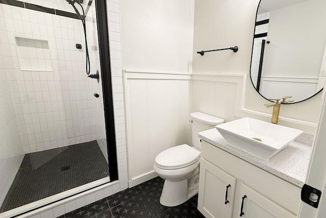 3815 Jefferson Rd, Paris, TX 75462 - full bath with a tile shower, toilet, wainscoting, vanity, and tile patterned flooring