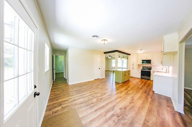 3815 Jefferson Rd, Paris, TX 75462 - unfurnished living room featuring light wood finished floors, baseboards, and a sink