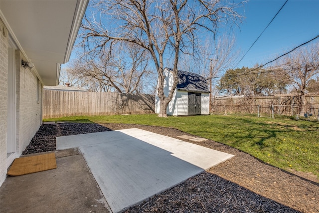 view of yard featuring a patio, an outbuilding, a fenced backyard, and a storage shed
