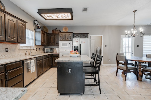 796 Ridge Rd W, Rockwall, TX 75087 - kitchen featuring appliances with stainless steel finishes, a sink, a chandelier, and plenty of natural light