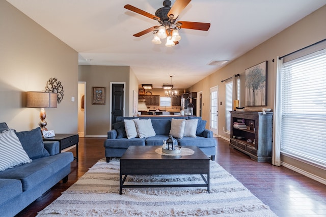 796 Ridge Rd W, Rockwall, TX 75087 - living area featuring a chandelier, dark wood-type flooring, baseboards, and a ceiling fan