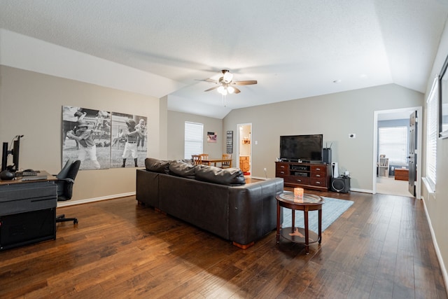 796 Ridge Rd W, Rockwall, TX 75087 - living area featuring lofted ceiling, a ceiling fan, dark wood-style floors, plenty of natural light, and baseboards