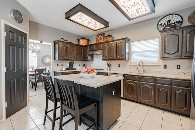 796 Ridge Rd W, Rockwall, TX 75087 - kitchen with a sink, stainless steel dishwasher, light tile patterned flooring, dark brown cabinets, and under cabinet range hood