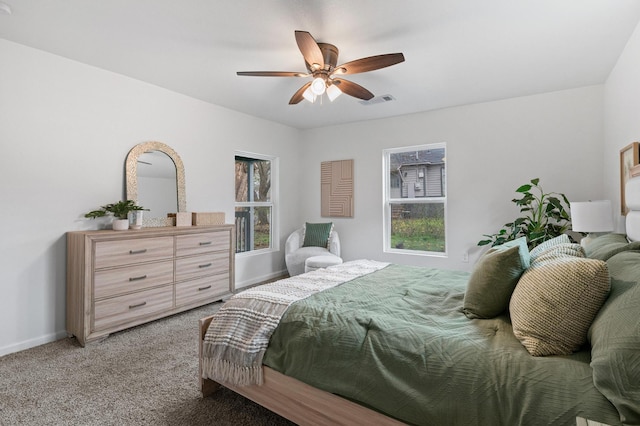 bedroom with light colored carpet, visible vents, ceiling fan, and baseboards