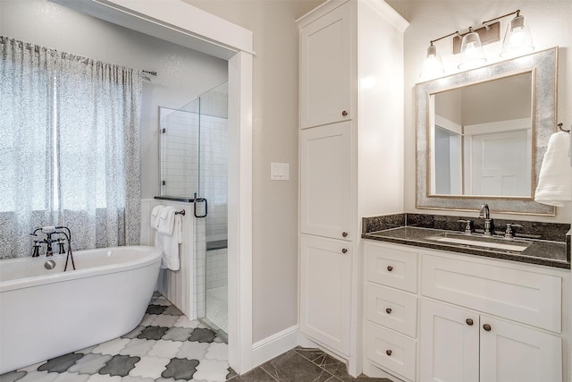 full bathroom featuring a soaking tub, baseboards, vanity, and a stall shower