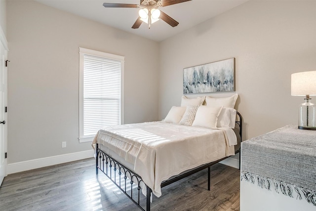 bedroom featuring baseboards, a ceiling fan, and wood finished floors