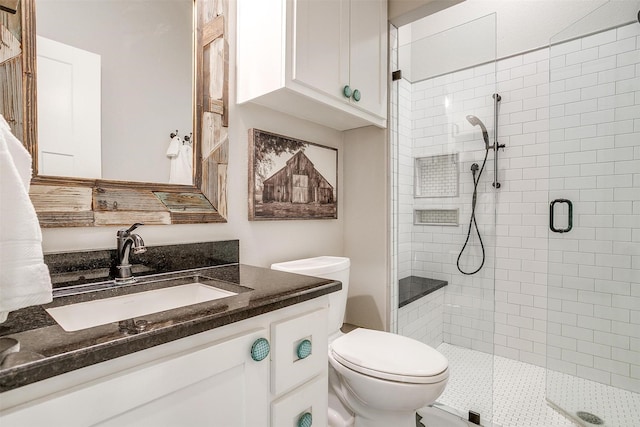 full bathroom with vanity, toilet, and a stall shower