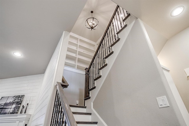 stairs with a chandelier