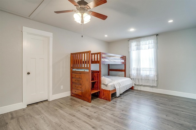 bedroom featuring baseboards, wood finished floors, and recessed lighting