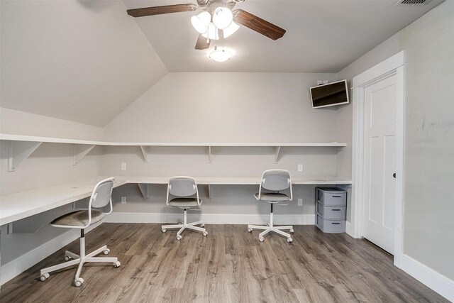 office space featuring vaulted ceiling, wood finished floors, visible vents, baseboards, and ceiling fan