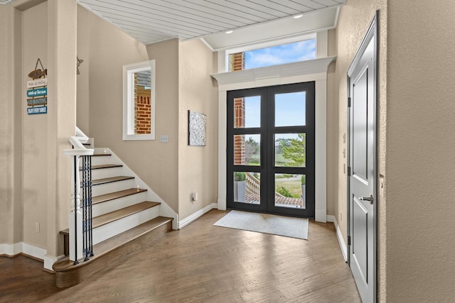 181 Monarch Dr, Denison, TX 75020 - entrance foyer featuring stairway, french doors, a textured wall, baseboards, and wood finished floors