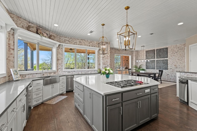 181 Monarch Dr, Denison, TX 75020 - kitchen with a chandelier, stainless steel gas cooktop, a sink, dark wood-style floors, and gray cabinets