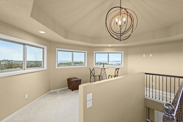 181 Monarch Dr, Denison, TX 75020 - stairs featuring baseboards, a raised ceiling, a healthy amount of sunlight, carpet floors, and an inviting chandelier