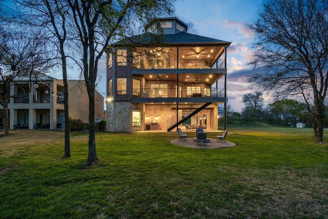 181 Monarch Dr, Denison, TX 75020 - rear view of house with stairs, a balcony, ceiling fan, a fire pit, and a lawn