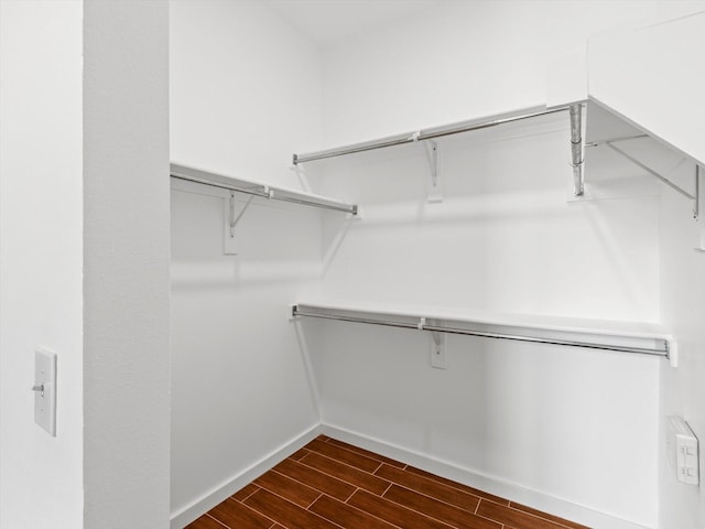 walk in closet with wood tiled floor