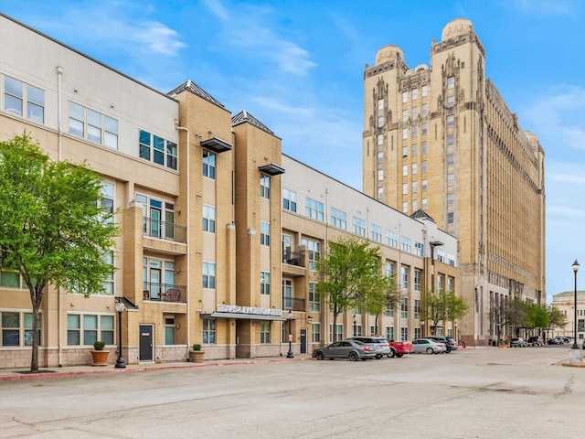 view of building exterior with uncovered parking