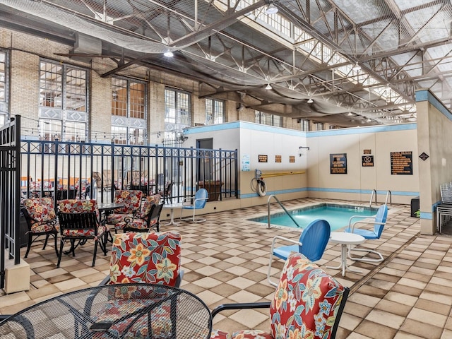 view of swimming pool featuring outdoor dining area, a patio area, and an indoor in ground hot tub