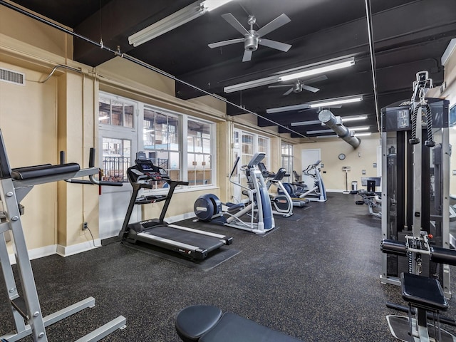 gym with visible vents, baseboards, and ceiling fan
