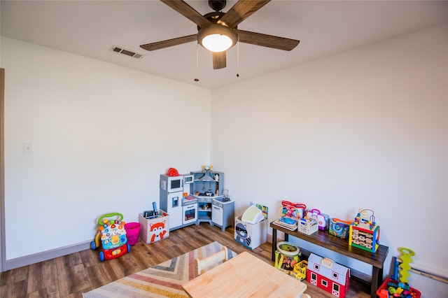 recreation room featuring visible vents, wood finished floors, and ceiling fan
