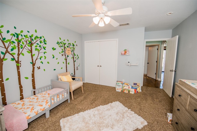 bedroom featuring a closet, visible vents, a ceiling fan, and carpet