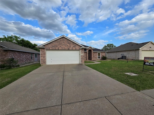 single story home featuring driveway, a garage, a front lawn, and brick siding
