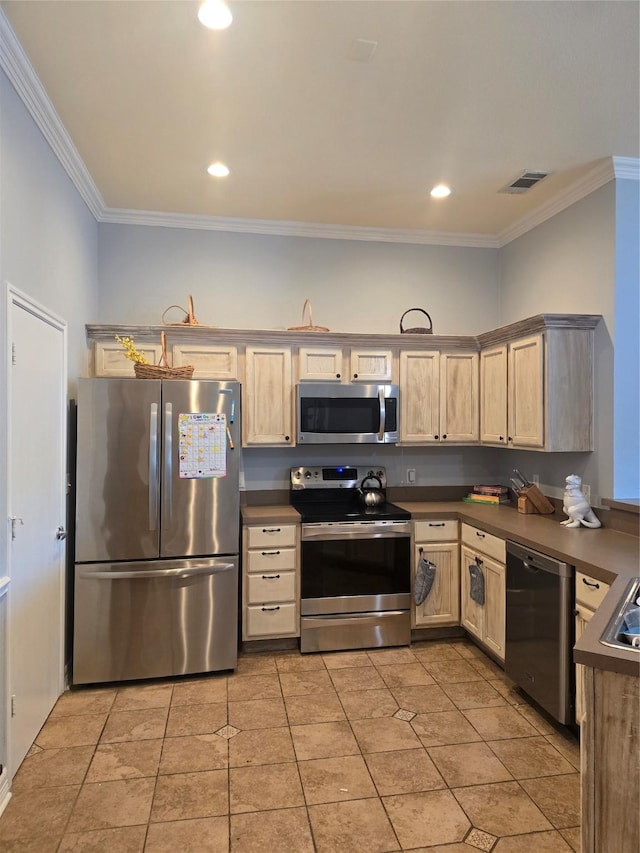 kitchen with crown molding, appliances with stainless steel finishes, and dark countertops