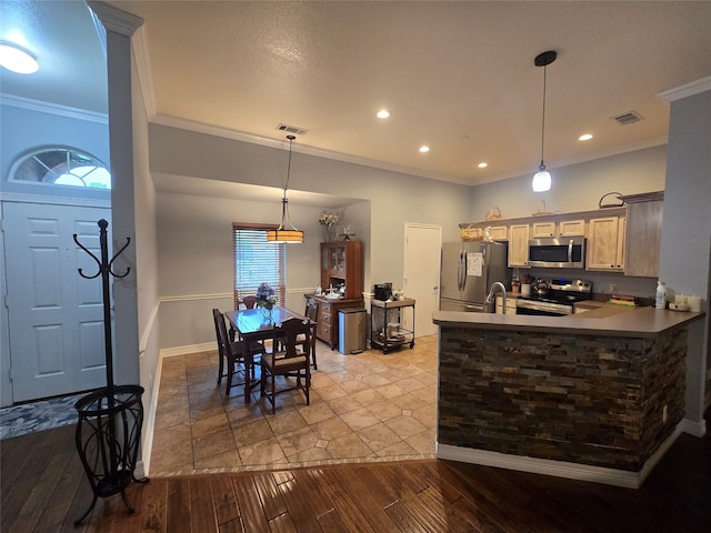 714 Green Acres Ln, Midlothian, TX 76065 - kitchen featuring appliances with stainless steel finishes, dark wood finished floors, crown molding, hanging light fixtures, and a peninsula