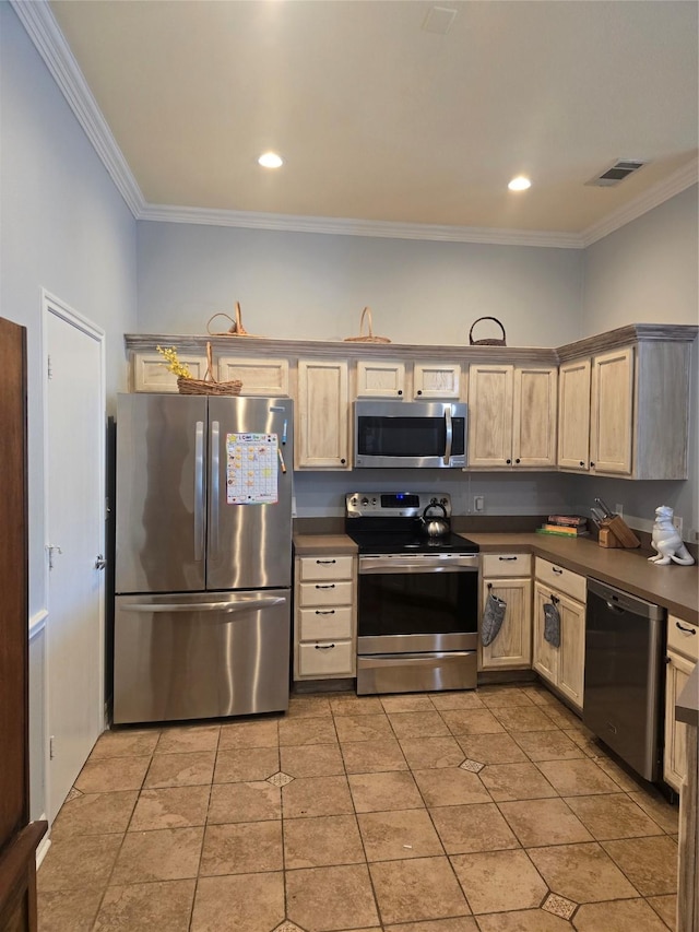 kitchen featuring appliances with stainless steel finishes, dark countertops, ornamental molding, and visible vents