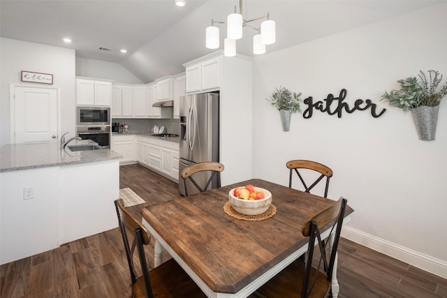 dining area with dark wood-style floors, vaulted ceiling, and recessed lighting