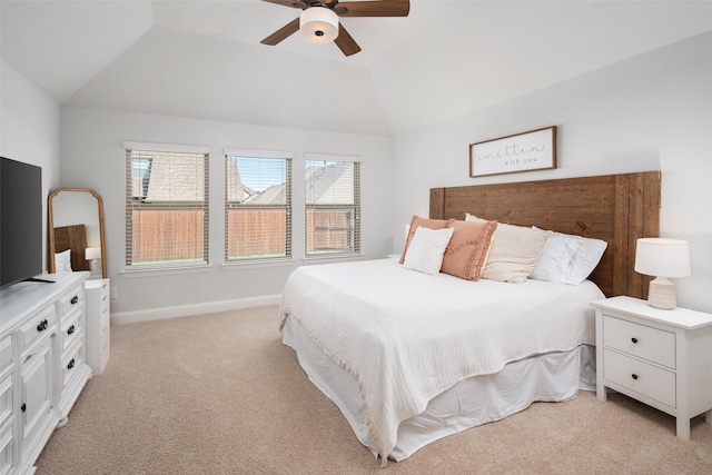 bedroom with a ceiling fan, baseboards, lofted ceiling, and light colored carpet