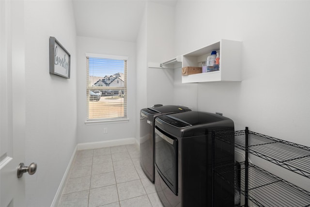 laundry room with washing machine and clothes dryer, baseboards, laundry area, and light tile patterned floors