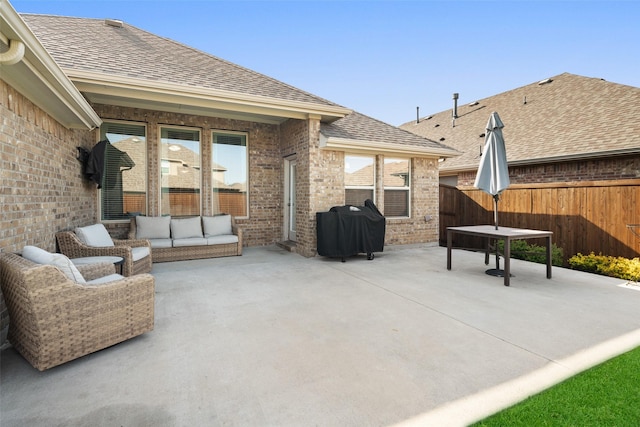 view of patio / terrace with grilling area, an outdoor living space, and fence