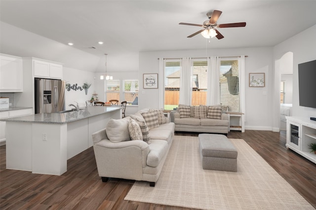 living area featuring vaulted ceiling, recessed lighting, baseboards, dark wood finished floors, and a ceiling fan