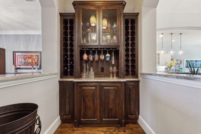 3960 Briar Tree Ln, Frisco, TX 75034 - bar area with baseboards, dark wood-style floors, and arched walkways