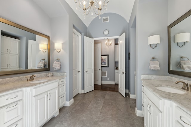 3960 Briar Tree Ln, Frisco, TX 75034 - bathroom featuring a chandelier, two vanities, lofted ceiling, and baseboards