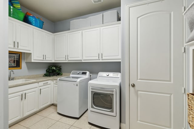 3960 Briar Tree Ln, Frisco, TX 75034 - laundry room featuring washing machine and dryer, cabinet space, and light tile patterned floors