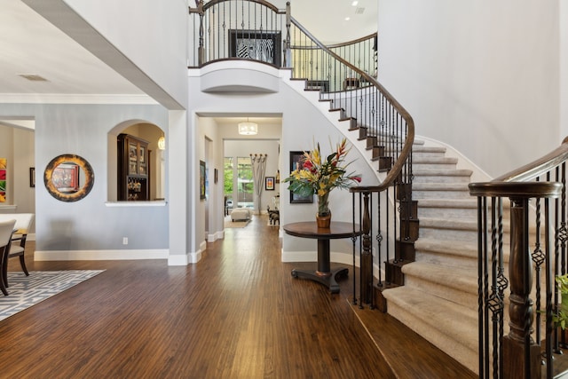 3960 Briar Tree Ln, Frisco, TX 75034 - foyer entrance featuring wood finished floors, stairway, baseboards, crown molding, and a towering ceiling