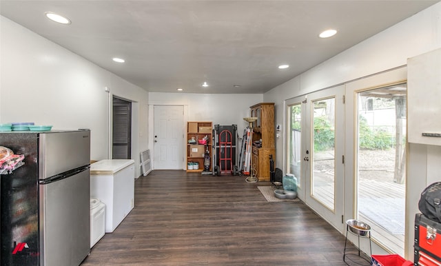 interior space with recessed lighting, freestanding refrigerator, and dark wood-type flooring