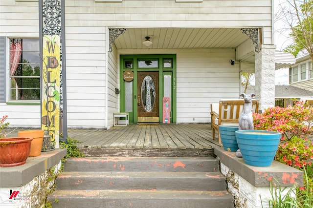 view of exterior entry with a porch