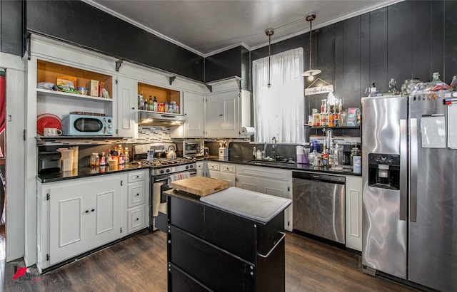 kitchen featuring a sink, under cabinet range hood, open shelves, dark countertops, and appliances with stainless steel finishes