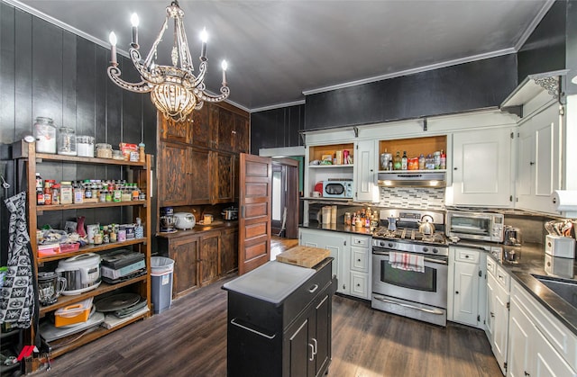 kitchen with decorative backsplash, gas range, open shelves, dark wood-style flooring, and a notable chandelier